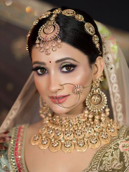A unique look with a pastel green lehenga and heavy gold jewelry. I created a dramatic eye look to balance the intricate details of the outfit.