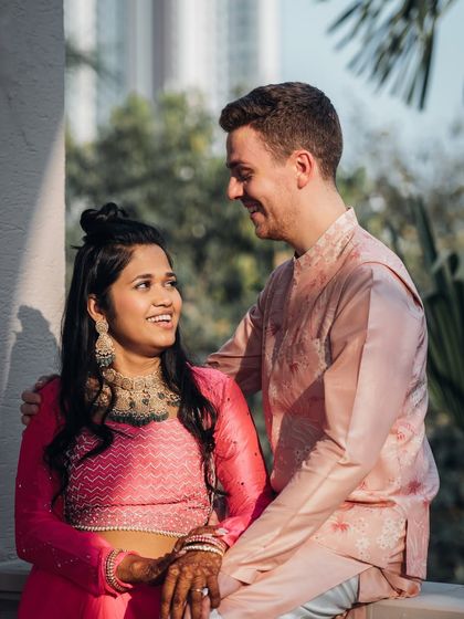 A candid moment from a pre-wedding event. The bride-to-be wears a half-up hairstyle, perfect for a Sangeet or Mehendi, allowing for comfort and style while she celebrates.