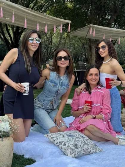 A group of friends posing at the chic picnic party. Our setups are designed to be the perfect backdrop for all your Instagrammable moments.