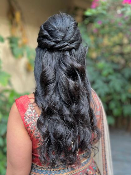 A clear back view of the elegant half-updo.