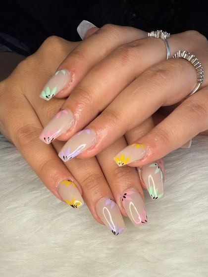 A playful and colorful set with pastel butterfly wing tips on coffin-shaped nails.