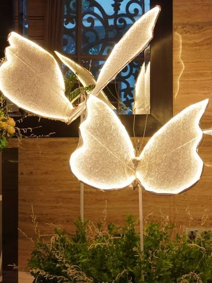 A close-up of a glowing butterfly sculpture. These custom pieces are perfect for adding a unique and enchanting element to a fairytale or garden-themed event.