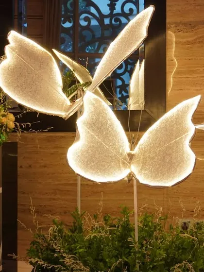 A close-up of the glowing butterfly decor. These artistic elements can transform a simple corner into a magical, interactive space for guests.