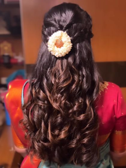 Another angle of the half-braided, curly hairstyle, showing the beautiful texture.