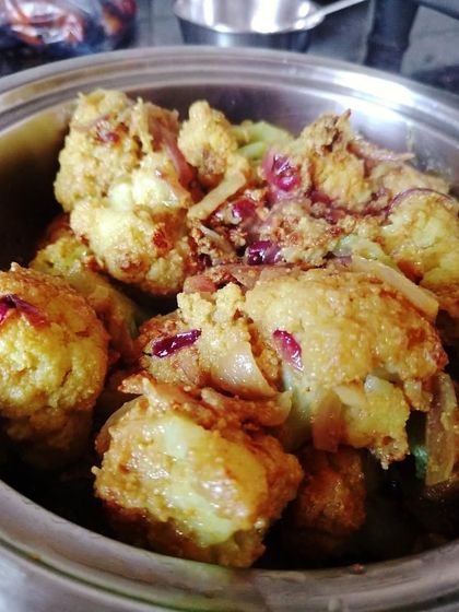 Roshiye Koshiye Phulkopi, a flavourful cauliflower preparation. The florets are cooked to be melt-in-the-mouth, beautifully absorbing the aromatic spices of the gravy.
