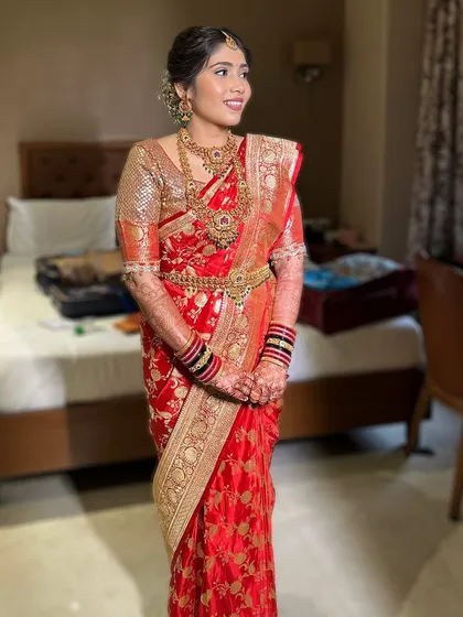A full view of the bride's stunning red silk saree and temple jewelry, paired with my signature soft glam makeup.