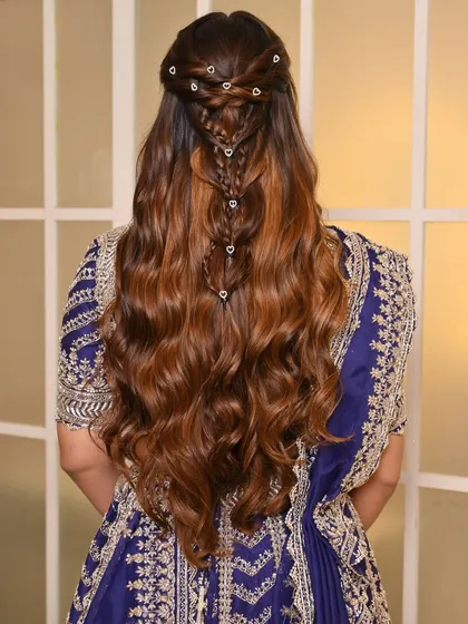 A view of the intricate hairstyle for the sangeet. The beautiful braid detail adds another layer of elegance to the overall look, proving that beauty is in every detail.