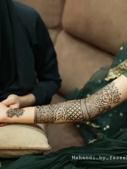 A beautiful shot of the bridal henna session, showing the art coming to life.