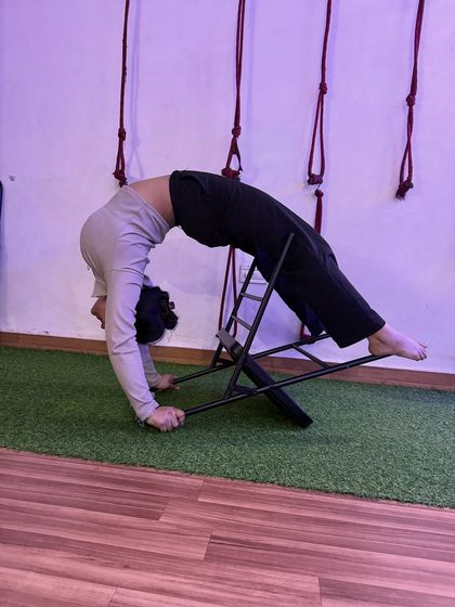 Another angle of the chair-supported backbend, showing how the prop assists in creating a perfect arch.