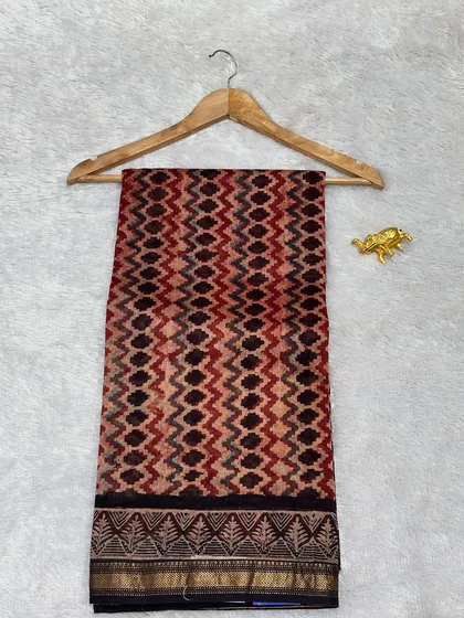 A unique Bagru printed Chanderi silk saree with a geometric chevron pattern. The mix of earthy red and black tones makes it a striking and stylish piece.