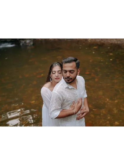 A tender and intimate portrait of a couple in the water. This shot focuses on their close embrace and the feeling of being in their own private world.