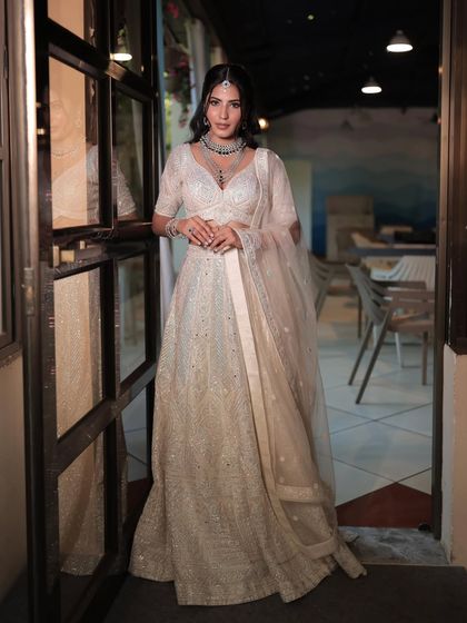 Another angle of the beautiful white lehenga, showing how the sheer dupatta and delicate jewellery create a dreamy and ethereal vibe.