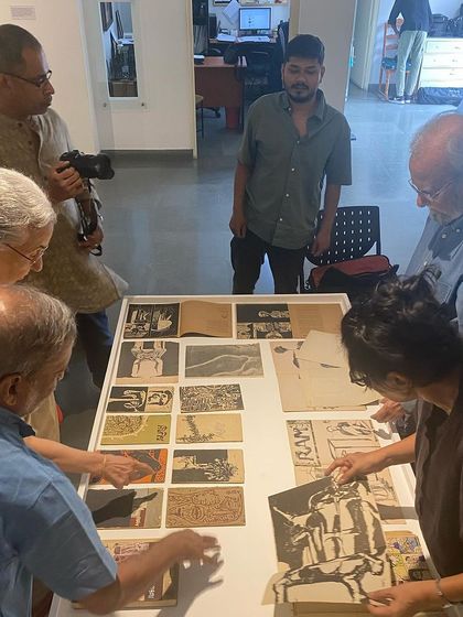 A close-up of the collaborative process of arranging the archival display.