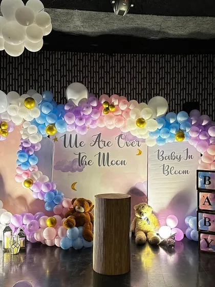 We are over the moon for this baby shower theme. We created a dreamy sky with pastel pink, blue, and purple balloons, fluffy white clouds, and adorable teddy bears for a sweet and memorable gender reveal party.