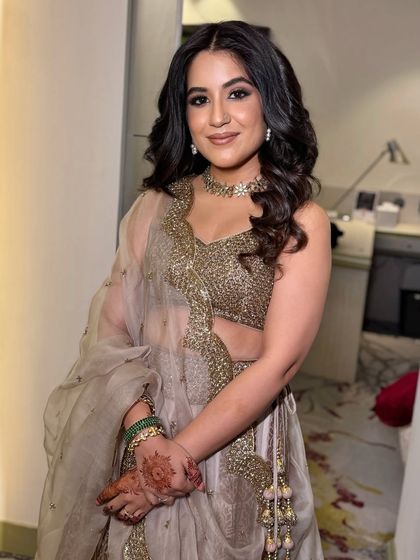 A full view of this stunning cocktail look. The makeup is bold and confident, designed to last through a night of dancing and celebration.