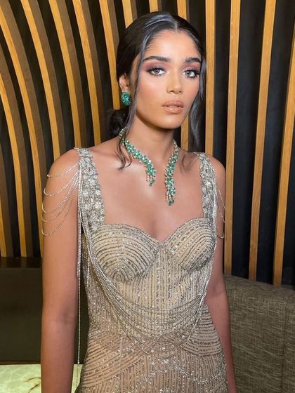 A full-length view of the beaded gown, showing how the soft makeup complements the intricate details of the dress.