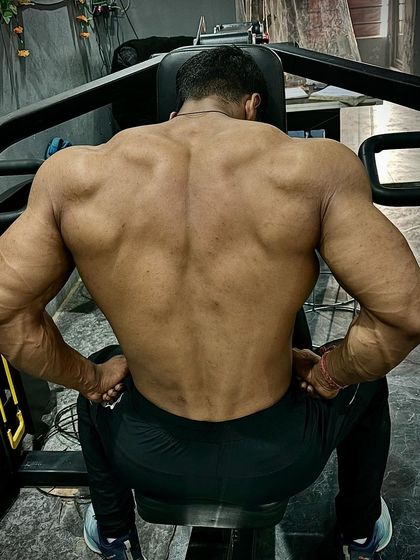 The back is where shows are won. This back double biceps shot shows the detail and thickness we've built.