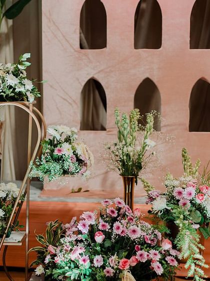 A wider shot of the beautiful decor, showing how the golden elements and floral arrangements come together to create a stunning ambiance.