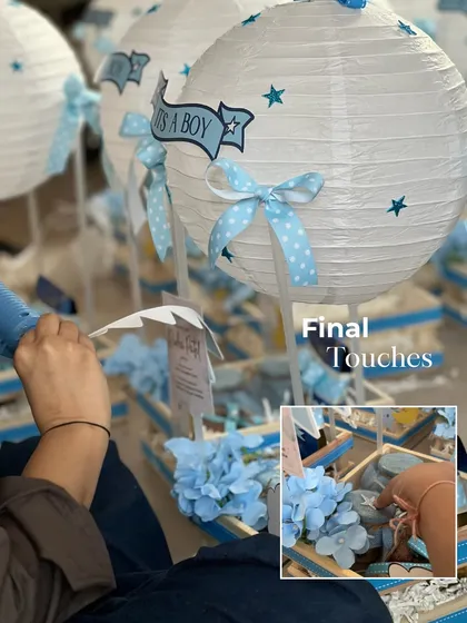Putting the final touches on the hot air balloon hampers. Each one gets a personalized tag and is carefully assembled to ensure it looks perfect.
