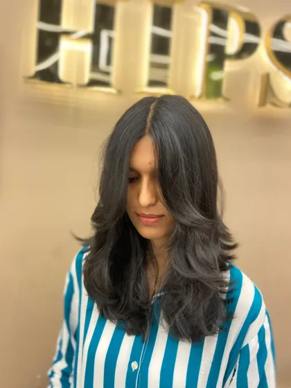 This client's new layered cut is styled with a center part, allowing the face-framing pieces to fall perfectly on either side.