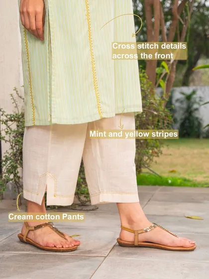 This image shows how to style our Suhani Mint A-Line Kurta with cream cotton pants. The cross-stitch details and mint and yellow stripes create a cohesive, elegant look.