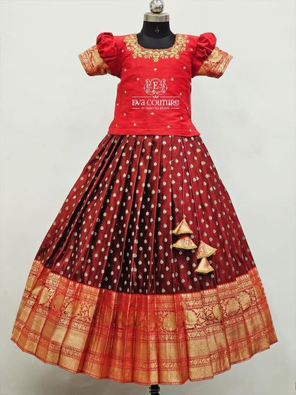 Another view of the classic maroon Pattu Pavadai, showcasing the full length of the skirt and the rich gold border.