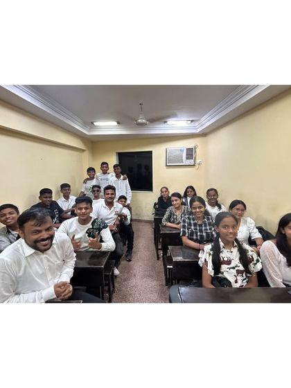 A smaller group of students at the Orlem branch, all dressed in black and white, smiling for the camera.