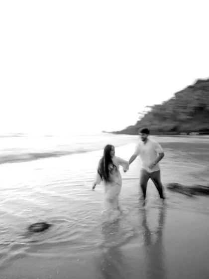 An artistic, motion blur shot in black and white, capturing the couple running along the shoreline. This technique adds a dreamy, ethereal quality to the pre wedding portrait, focusing on the feeling of the moment rather than perfect detail.