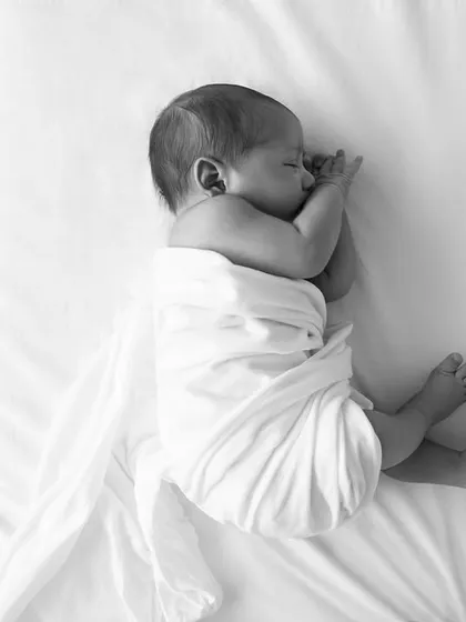 A classic black and white shot of my own son, sleeping peacefully while swaddled. The simplicity of the composition puts all the focus on his serene expression.