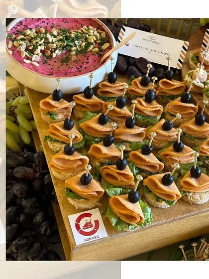 An elegant canapé of chicken salami and olives on a small toast point. These non-vegetarian bites are a classic and sophisticated choice for cocktail parties.