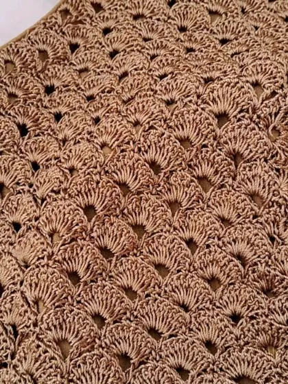 A close-up of the intricate fan stitch pattern on our golden zari yarn blouse. This detail shot highlights the skill and precision that goes into every piece.
