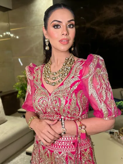 A close-up on the smokey eye and flawless base, paired with a statement necklace. This is a perfect example of festive, high-glam makeup.
