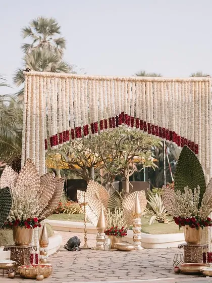 A photo backdrop area using traditional floral strings and decor elements.