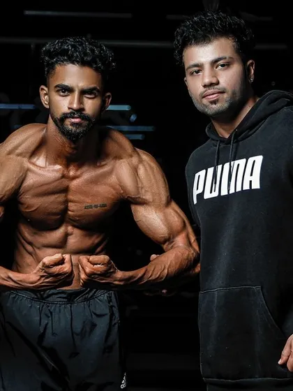 Posing with my client after his successful 12-week prep. He brought an incredible package to the stage, and I'm proud to have coached him.