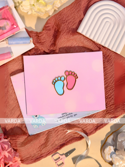 A sweet and simple baby shower invitation featuring the adorable motif of tiny baby feet in pink and blue. The minimalist design on a soft pink card is a charming way to announce the upcoming arrival.