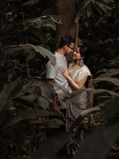 A romantic portrait of a couple surrounded by the deep greens of a forest. This kind of nature-filled pre-wedding photography is perfect for couples who love the outdoors.