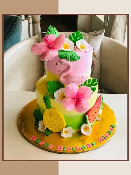 This vibrant, tropical-themed birthday cake features a flamingo, pineapple, and hibiscus flowers. I can craft a custom cake to match any party theme you have in mind.