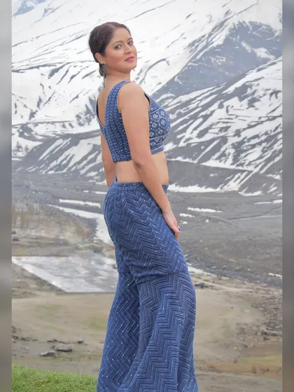 A side profile of the blue palazzo pants and crop top set.