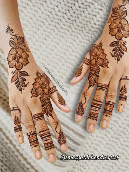 A delicate floral design with leafy vines and detailed finger work.