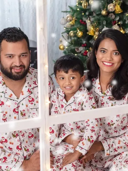 Cozy and coordinated! This family looks picture-perfect in their matching Christmas pajamas, ready for a story by the fireplace.