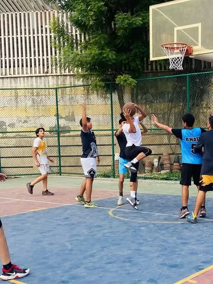 A player jumps for a rebound amongst a crowd. We teach techniques for boxing out and timing jumps to secure possession.