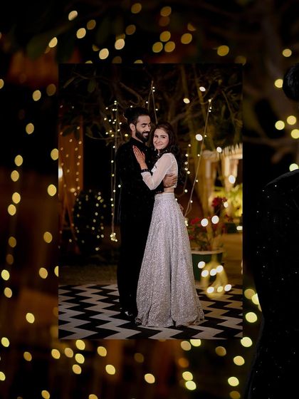 A romantic shot of the couple framed by fairy lights during their engagement night. This creative framing adds a dreamy and intimate feel to the portrait.