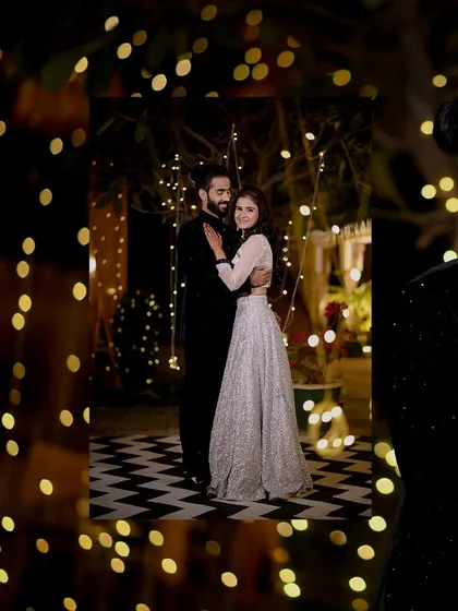 A romantic shot of the couple framed by fairy lights during their engagement night. This creative framing adds a dreamy and intimate feel to the portrait.
