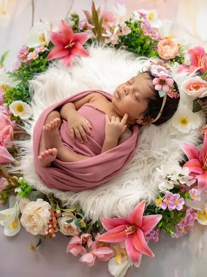 A beautiful baby girl sleeping in a nest of flowers. This is the same sweet moment as my featured photo, showing how we capture different angles to create a full gallery.