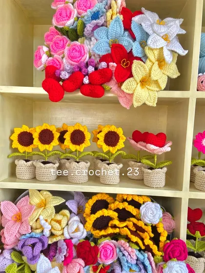 A mix of my creations on the shelf, including potted sunflowers and heart flowers.