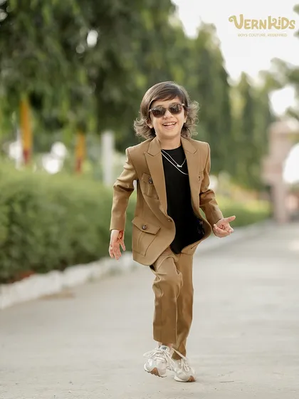 Capturing the pure joy of a boy who feels great in his clothes. This custom-made shacket set in a stylish tan color is designed for movement, making it the perfect blend of cool and comfortable for any active young man.