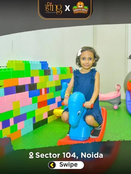 A young guest enjoys a ride on a rocking horse in our toddler area, with a wall of giant building blocks behind her. I provide a variety of toys for imaginative play.