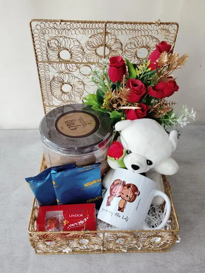 Another one of my Valentine's Day creations. This gold wire box hamper includes a teddy bear, a romantic mug, and a selection of fine chocolates, perfect for your special someone.