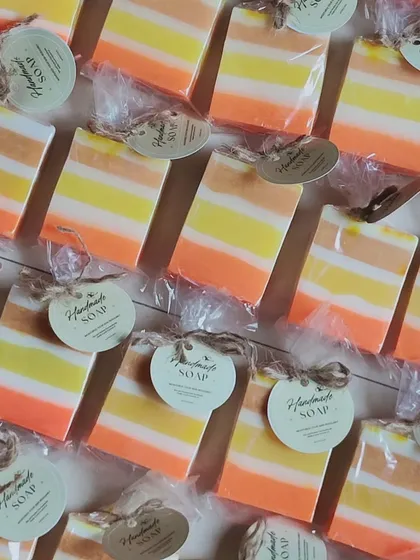 A large batch of my popular kesar milk striped soaps, individually wrapped with a "Handmade Soap" tag.