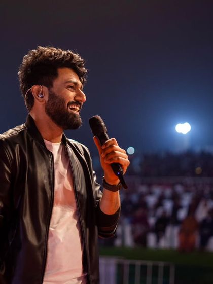 A smiling Mithoon interacting with the crowd at the beach festival.